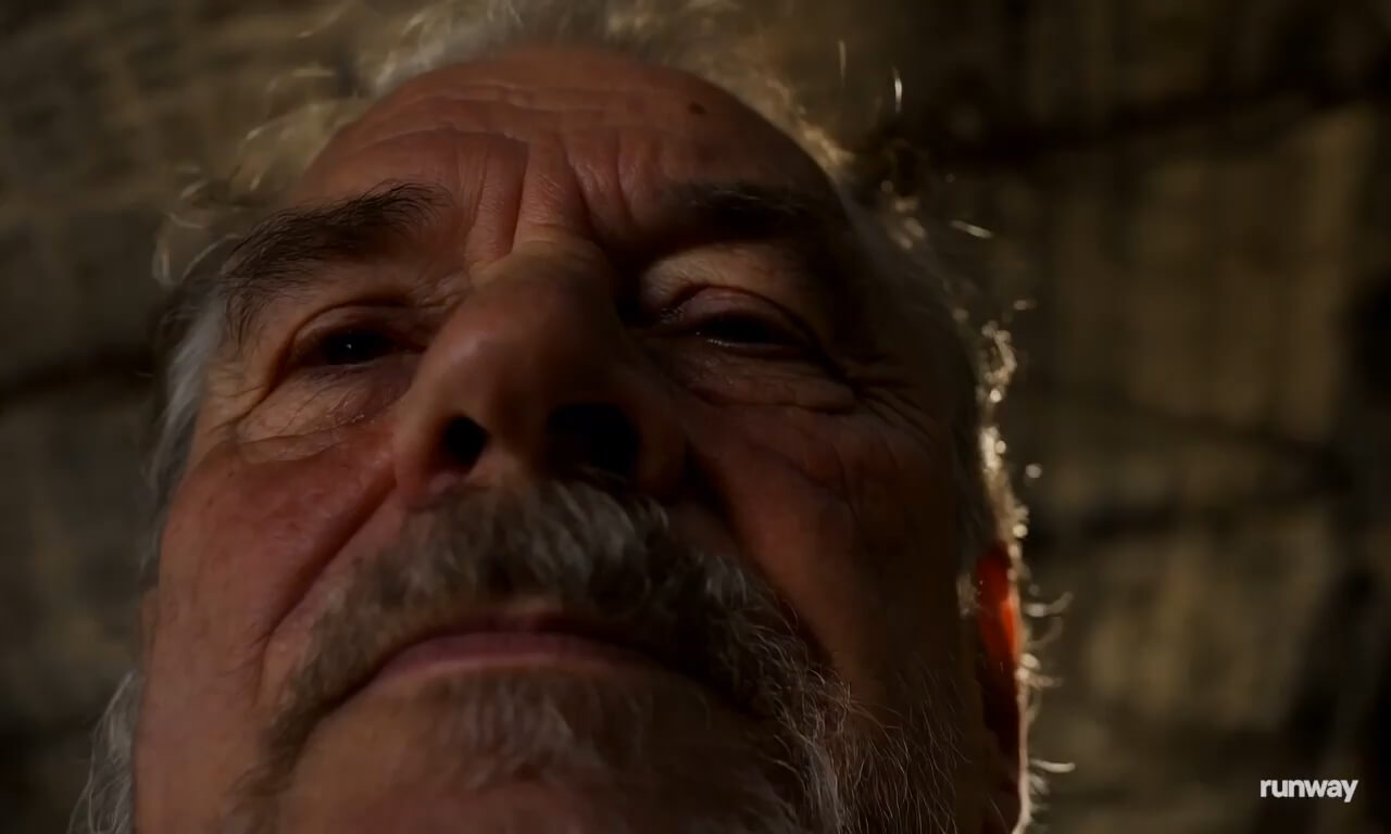 A close up of an older man in a warehouse