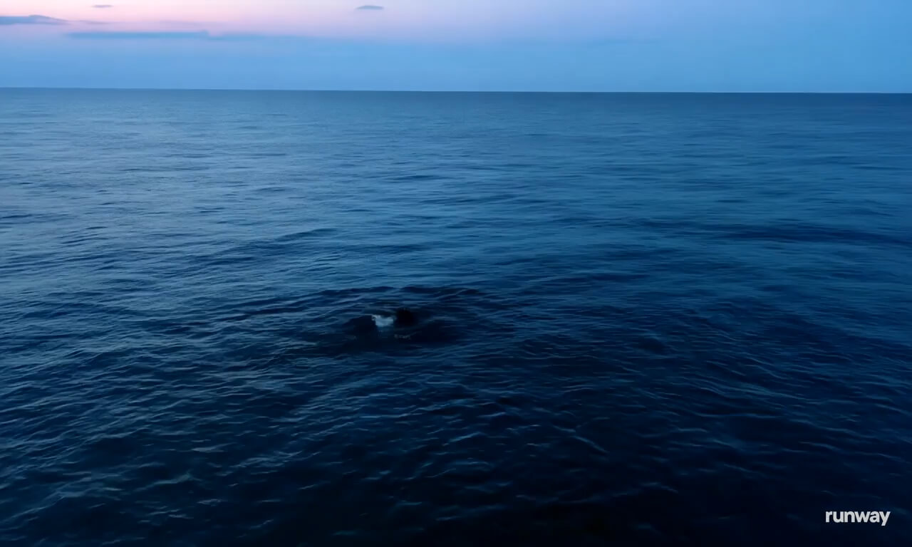 Aerial shot of the ocean. a maelstrom forms in the water swi