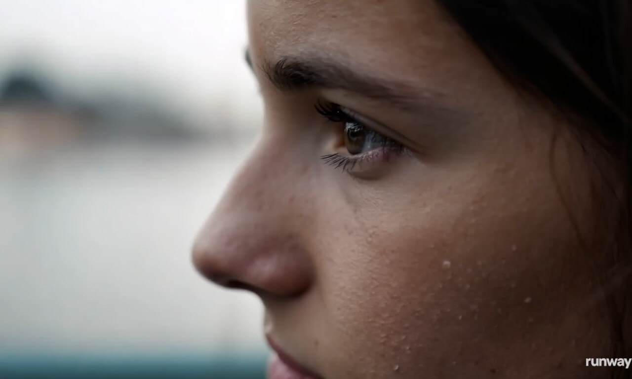 Macro shot to the face freckles of a young woman trying to l