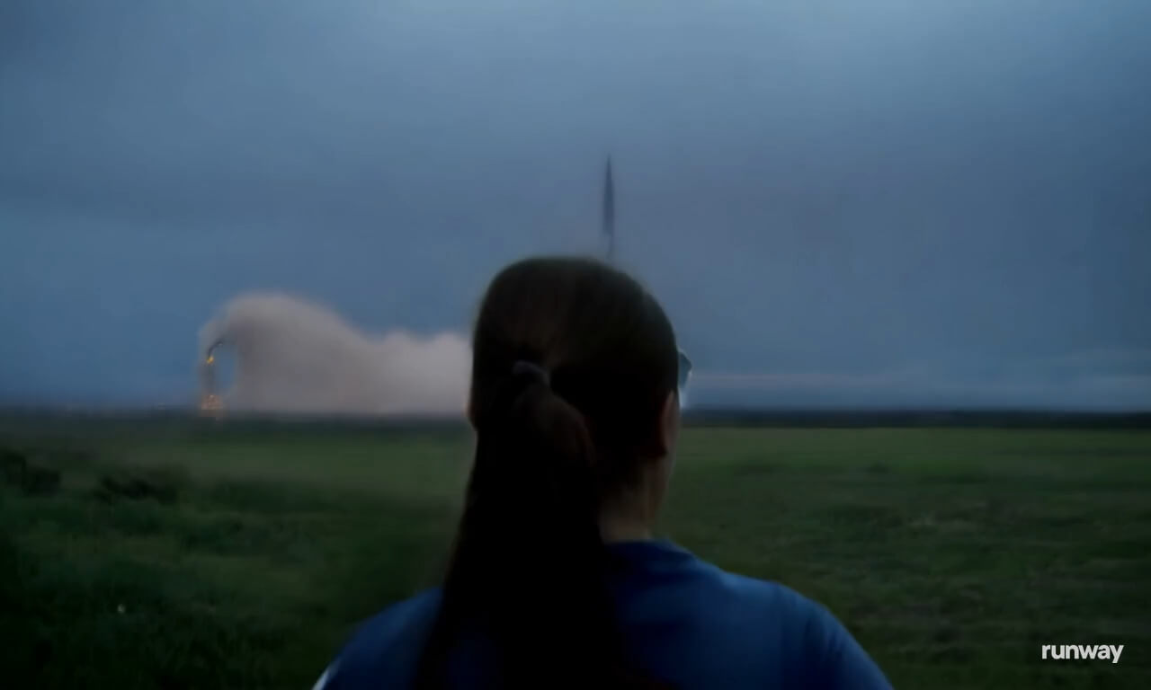 Over the shoulder shot of a woman running and watching a roc